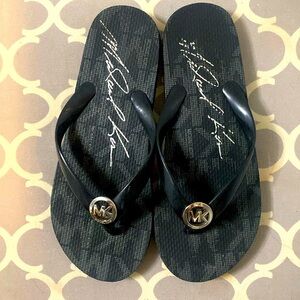 Gently used Michael Kors youth flip-flops, size 1 Black